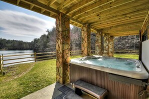Soak your worries away in the hot tub overlooking the lake