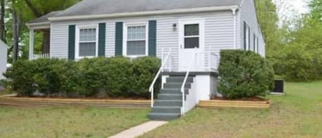 House from the street. Access is on the left side by driveway. 