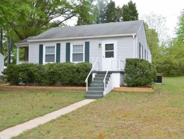House from the street. Access is on the left side by driveway.