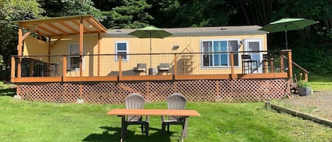 The big, new deck has plenty of space for relaxing in sun, shade, or rain. 