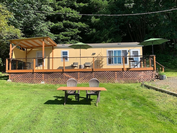 The big, new deck has plenty of space for relaxing in sun, shade, or rain. 