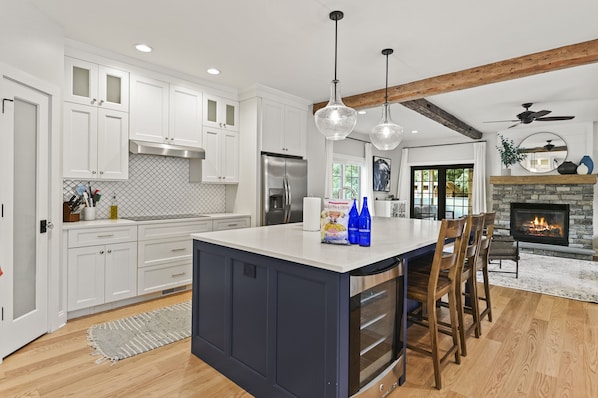 Kitchen with large island with seating for 5 and wine fridge