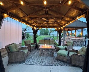 {Outside} Gather under the glow - cozy up for laughter and fireside chats.