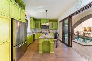 Modern kitchen with professional stove, wine fridge and up-to-date appliances