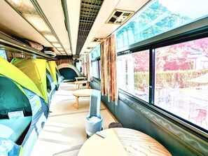There are 3 single tents and 1 double size tent on the bus. I can move the table away and give you a spare mat. (Please contact us in advance)