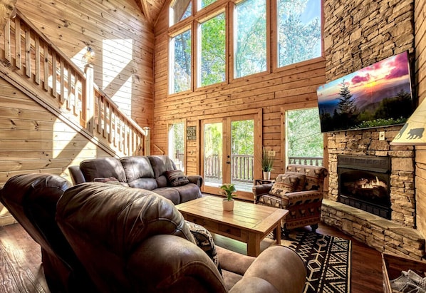 Enjoy the natural light as you relax in front of the fireplace and watch your favorite show on the cabin's stunning 65-inch, 4K HDTV.