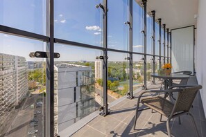 The furnished balcony offers a perfect spot for morning coffee with a view.