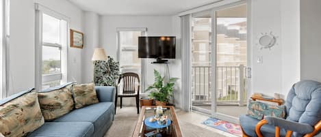 The open living area with a Smart TV and access to the private balcony