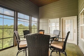 screened in back patio with a TV