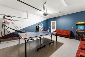 Garage was turned into a game room. 2 Arcade games, pingpong and basketball.