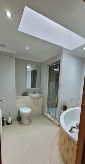 Main family bathroom with corner bath and walk in shower