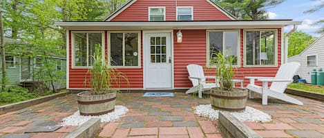 A gorgeous front patio to relax in a set of Adirondack chairs!