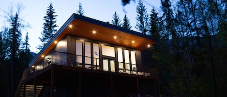 Night view of the cabin with lights around the cabin.