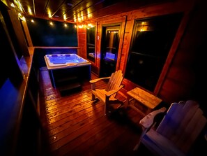 Large deck with rockers and hot tub.