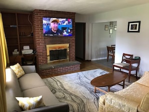 Living room with fireplace with an insert you can use for heat or ambiance.