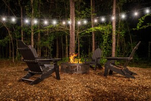 Place your favorite beverage in the cup holder and catch up on the day's events at the firepit under the Edison lights or the starry night sky