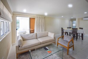 The open plan living and dining area of apt 2 leads out to the patio