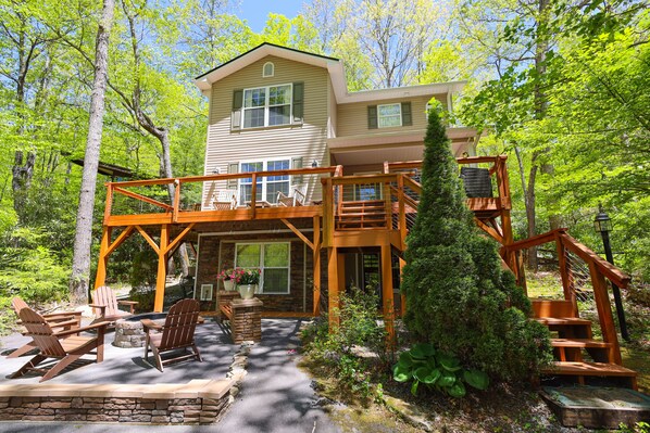 Side view of the front exterior and steps leading up to the deck.