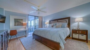 Primary bedroom with attached bathroom and balcony access