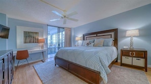 Primary bedroom with attached bathroom and balcony access
