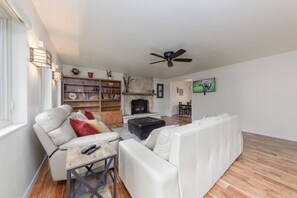 Relax in the inviting living area featuring a wood-burning fireplace.