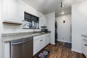 Cook up family favorites in the modern kitchen with stainless steel appliances and washer and dryer.