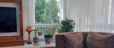 A living room with the view of a lemon tree 