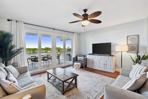 Living Area with Lake and Light Show Views, Flat Screen TV, Sleeper Sofa and Private Balcony Access