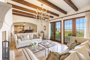 The formal living room offers comfortable seating and breathtaking views of the vineyards