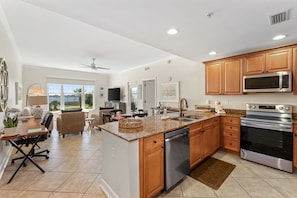The fully equipped kitchen features granite countertops and stainless-steel appliances.