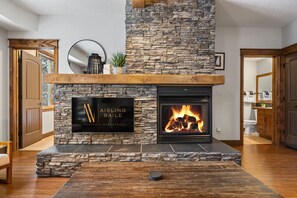 Living room with a smart TV & a gas-lit fireplace