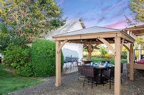 Beautiful outdoor dining and entertaining area.  Stay cozy by the fire. 