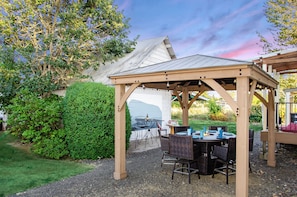 Beautiful outdoor dining and entertaining area.  Stay cozy by the fire. 