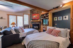 The living area has a pullout Queen size sofa bed and a Queen size Murphy bed