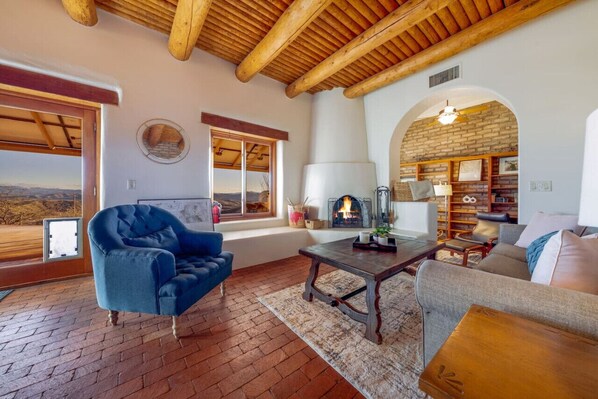 Grand living room, wood-burning fireplace, and epic mountain and big sky views