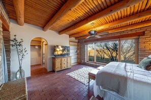 Primary bedroom with king-size bed and beautiful views from the room's large windows