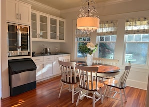 Breakfast nook with morning light and bar with wine cooler and ice maker