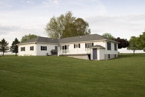 View from the back.  Garage and living room entrance off of deck.  Basement door