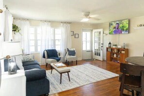 Living Room: Sofa and 2 chairs, smart tv, games, books, throw blankets