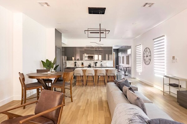 Spacious living room with 142 inch Sofa facing a 75 inch Smart TV
