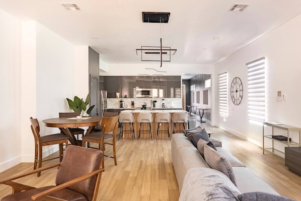 Spacious living room with 142 inch Sofa facing a 75 inch Smart TV