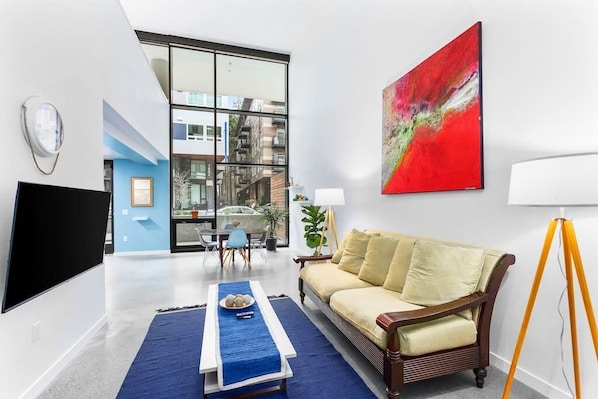 Living room with floor to ceiling windows with privacy and black-out blinds.