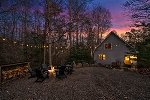 Relax by the cozy fire-pit located just steps outside the cabin.