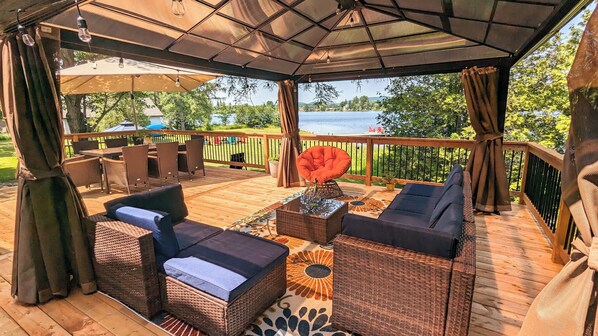 Large outdoor deck with view of the lake. Comfortable seating/eating areas.