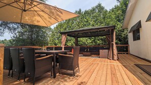 Large outdoor deck with view of the lake. Comfortable seating/eating areas.