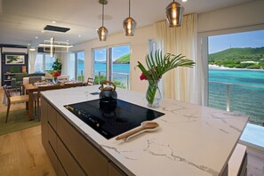 Enter into the property in the kitchen, a wall of windows affords a constant view.