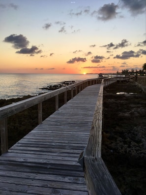 Watch the sun sink into the sea as you sip a cocktail on another day in paradise