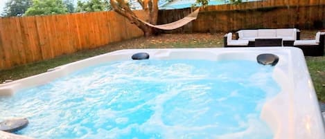 new hot tub, hammock, outdoor sectional, string lights, outdoor games, BBQ. 
