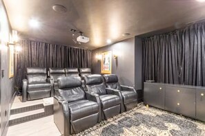 Ultimate Movie Haven: Theater room with plush leather recliners, large screen