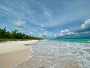 French Leave Beach facing north. A mile-long crescent of pink sand, famously well protected by a barrier reef.